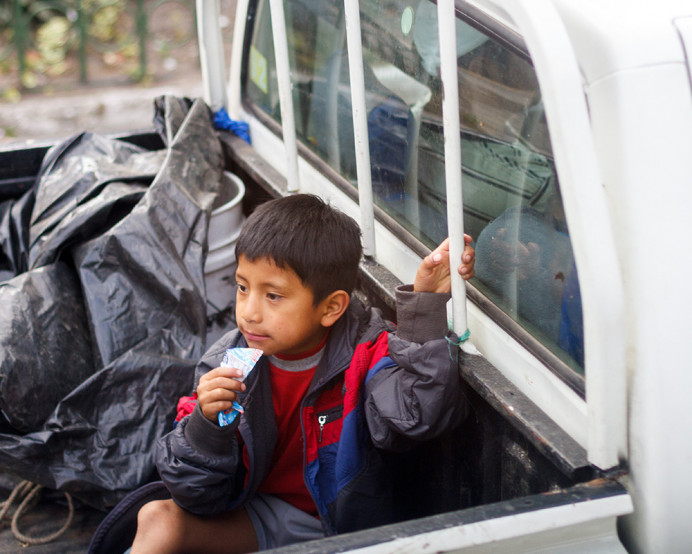 Young boy in the back of a pickup truck. Quito.