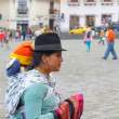 Woman selling scarves, with baby. Quito.
