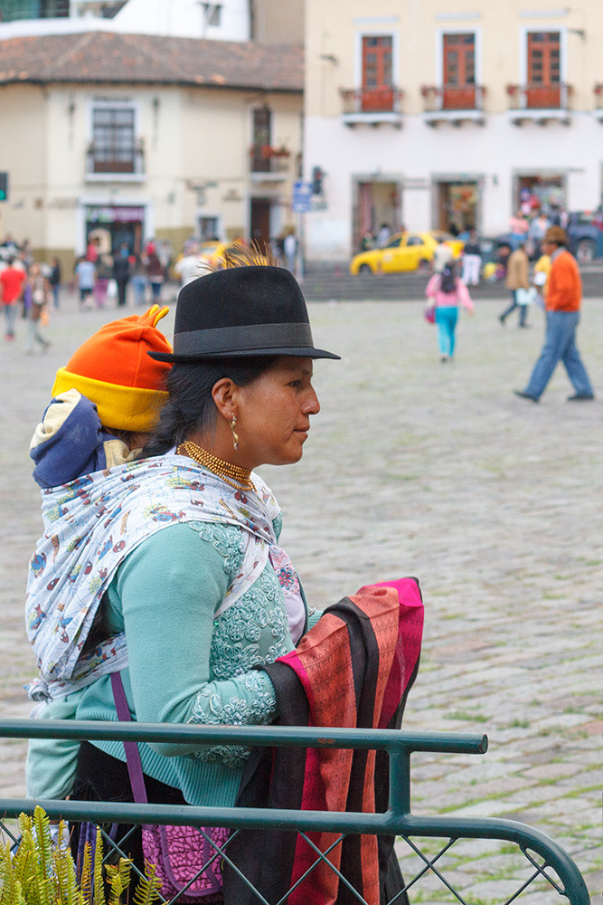 Woman selling scarves, with baby. Quito.